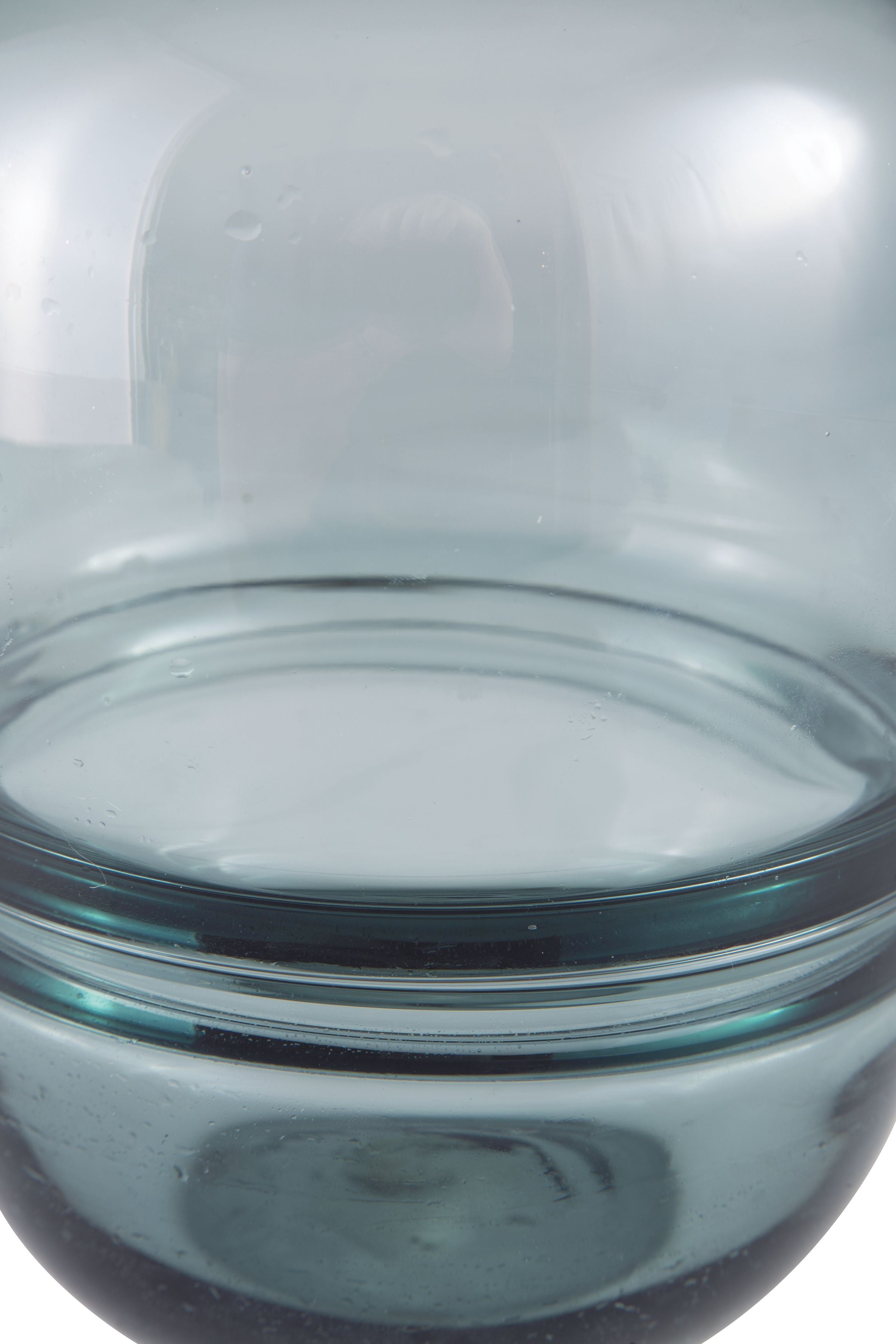 Teal glass vase opening view, smooth rim and translucent curved sides.