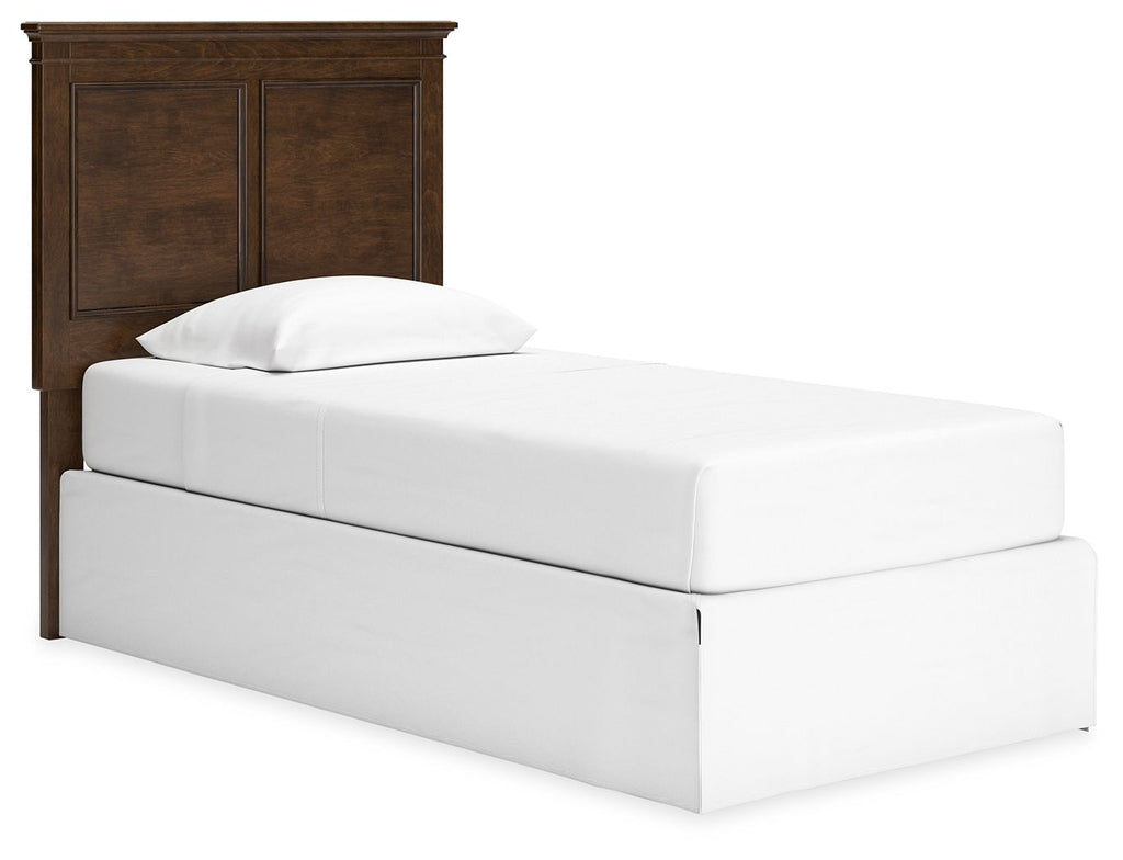 Twin panel headboard with brown wood finish behind a white twin bed