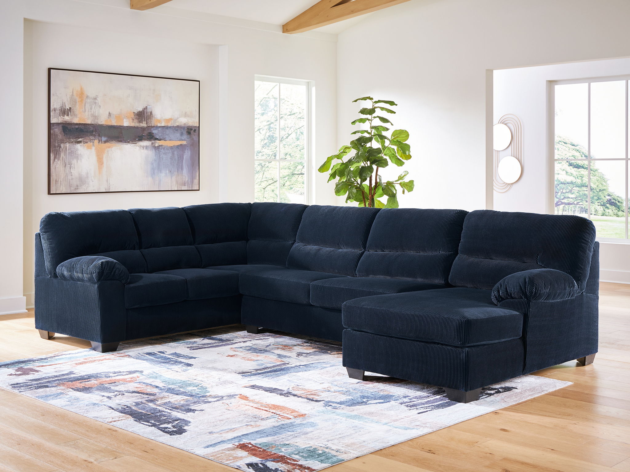 Navy sectional sofa with corner chaise and tufted back cushions