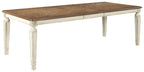 Rectangular dining table with brown wood top and white carved legs