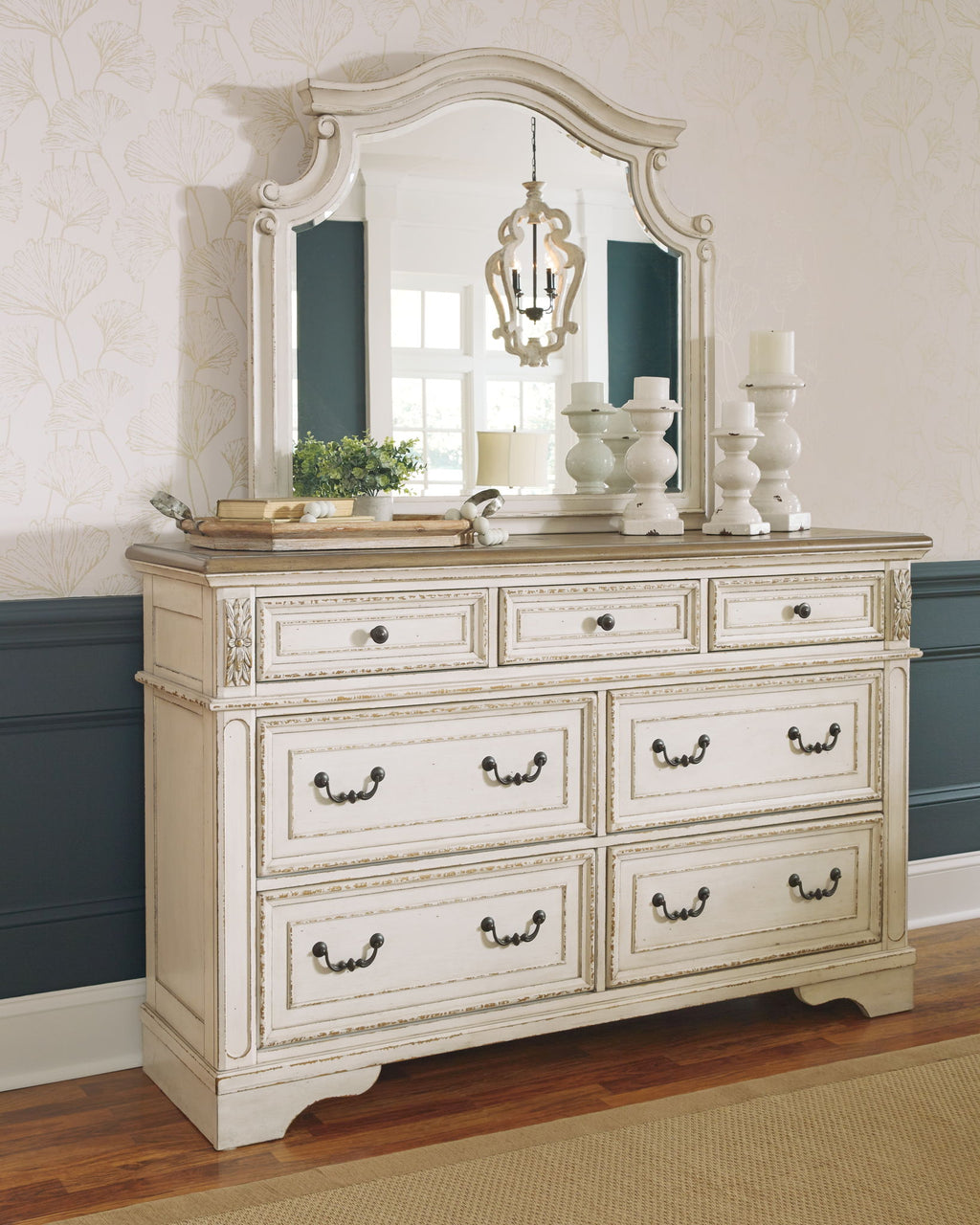 White dresser with mirror and six drawers, ornate detailing and vintage-style drawer pulls.