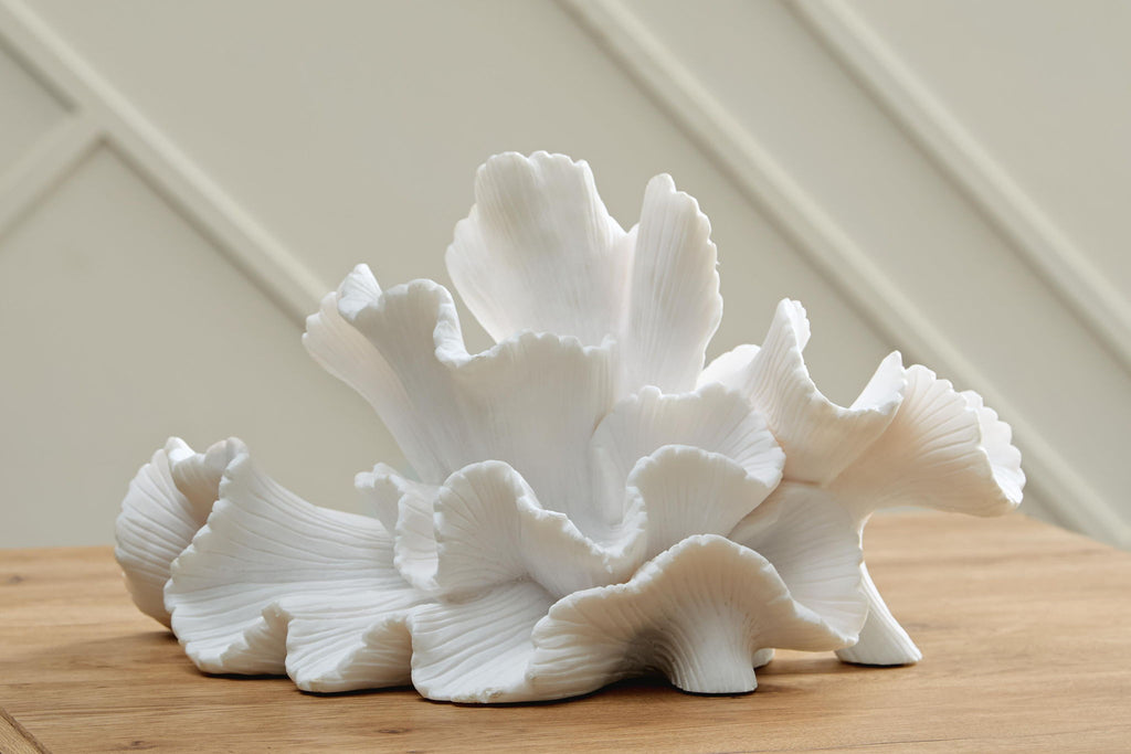 White coral sculpture with broad fan petals and curled, ribbed edges