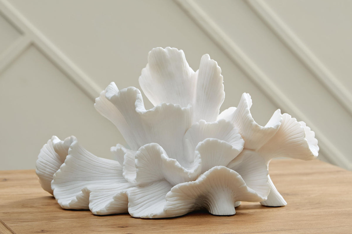 White coral sculpture with broad fan petals and curled, ribbed edges
