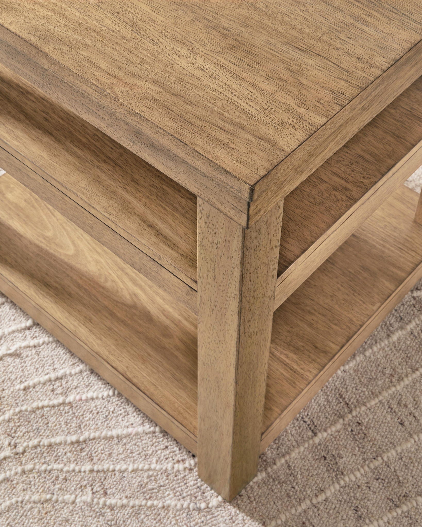 Natural wood end table corner detail with beveled edges and lower shelf