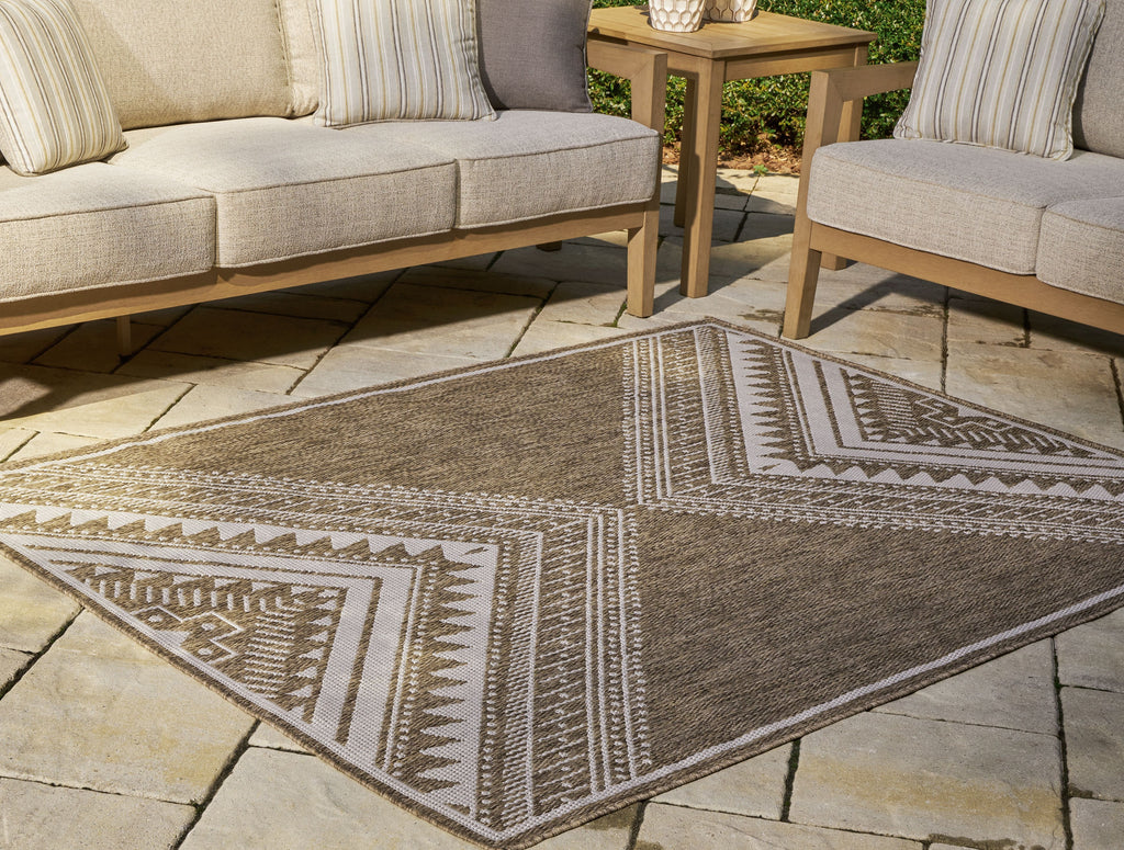 Brown area rug with cream tribal geometric lines, corner edge visible