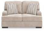 Taupe loveseat with two back cushions and two gray striped pillows, low black legs