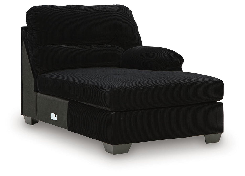 Onyx black corner chaise with front panel pocket detail and low metal legs