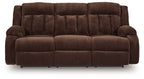 Chocolate brown reclining power sofa with three-seat cushions and padded armrests