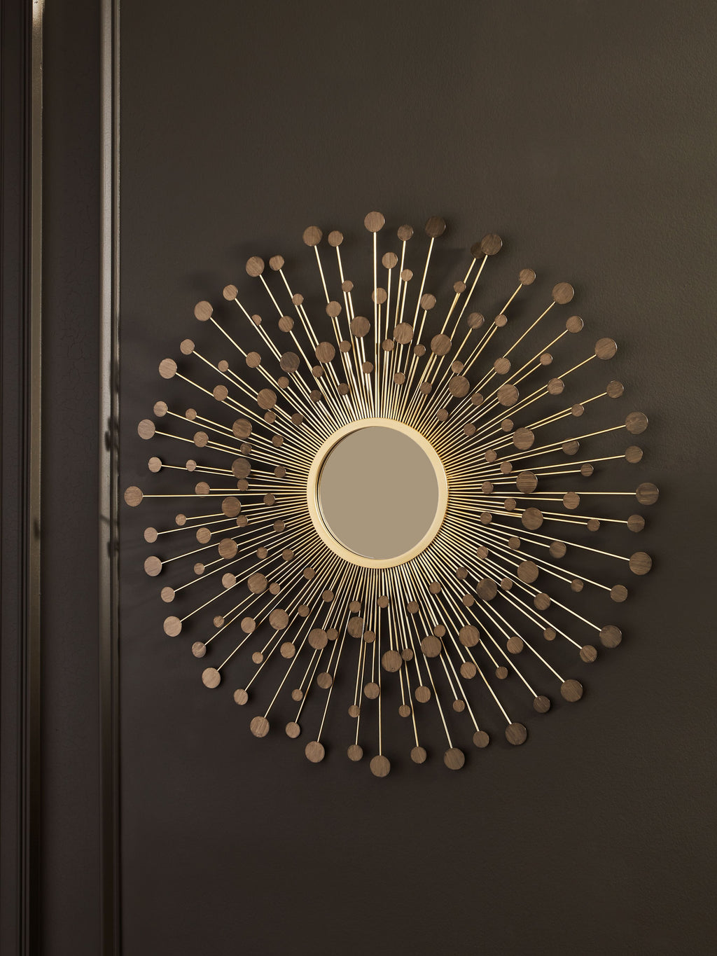 Accent wall mirror with round center mirror and bronze-gold radiating metal rod design