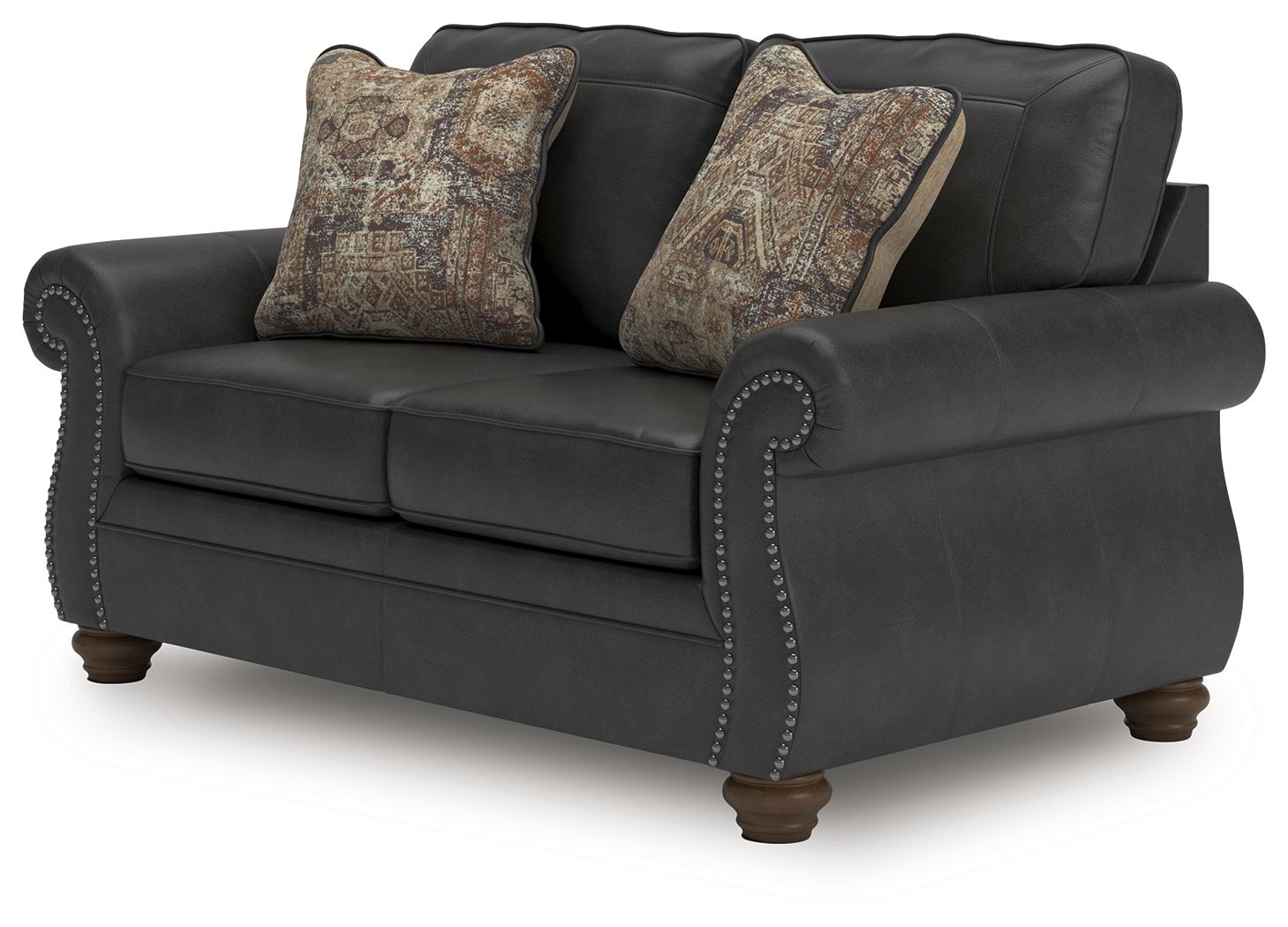 Dark gray loveseat with nailhead trim and two patterned throw pillows