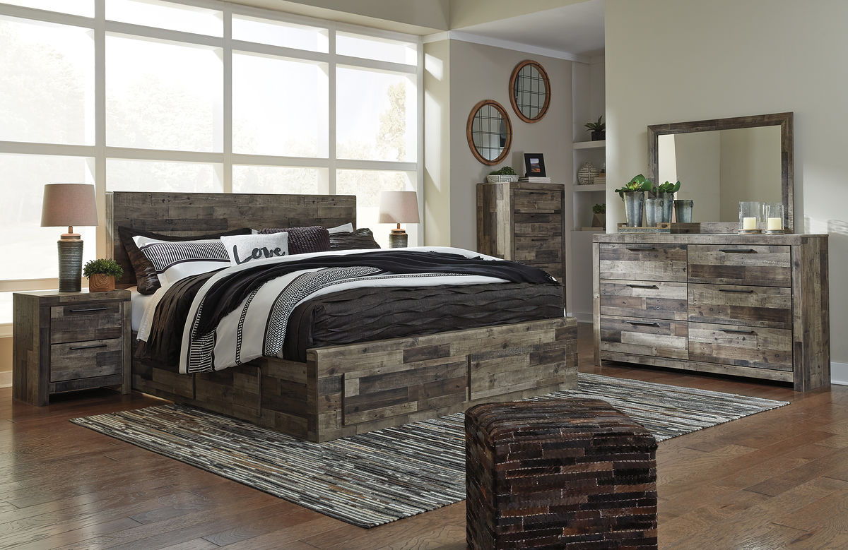 Panel bedroom set with panel bed and dresser with mirror in rustic gray wood, striped bedding.