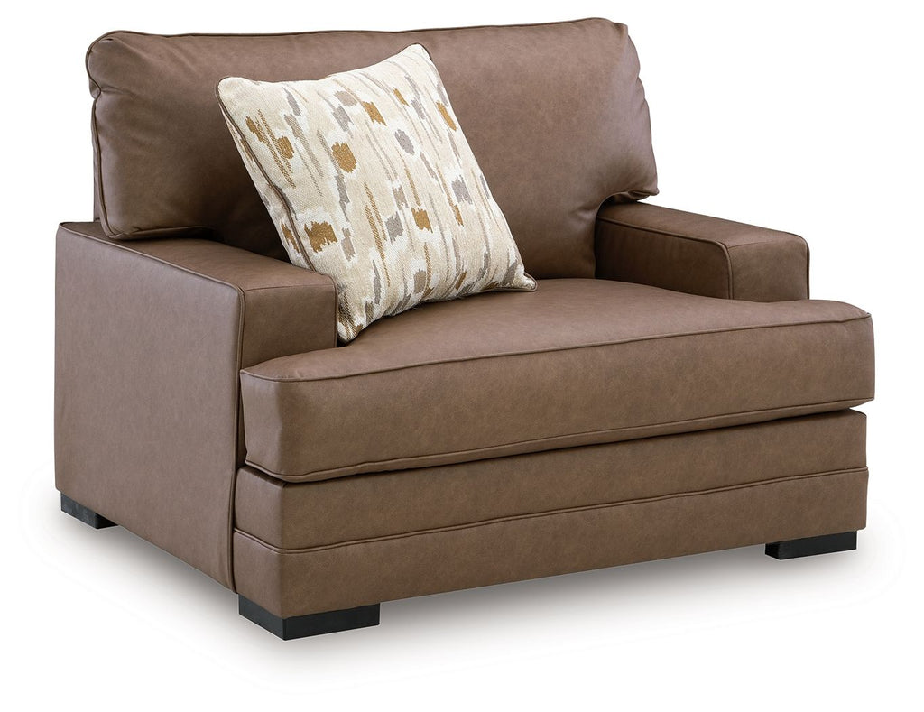 Caramel brown chair and a half with front seat and patterned back pillow