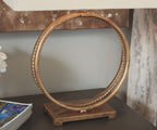 Antique gold metal table lamp with circular ring base and beige fabric shade