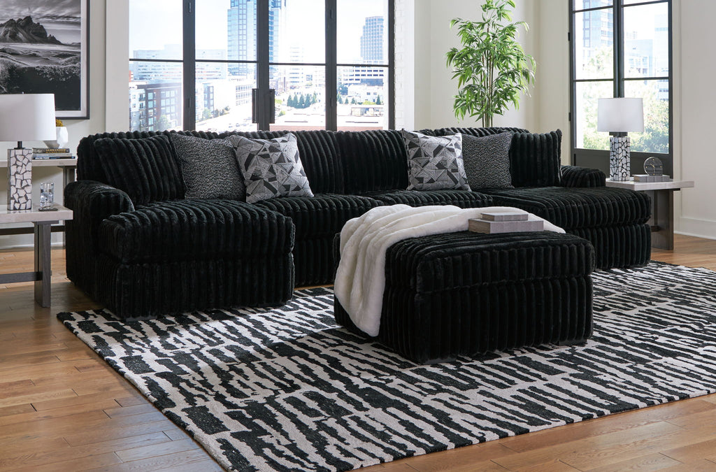 Black sectional sofa set with chaise lounge and coordinating ottoman pieces