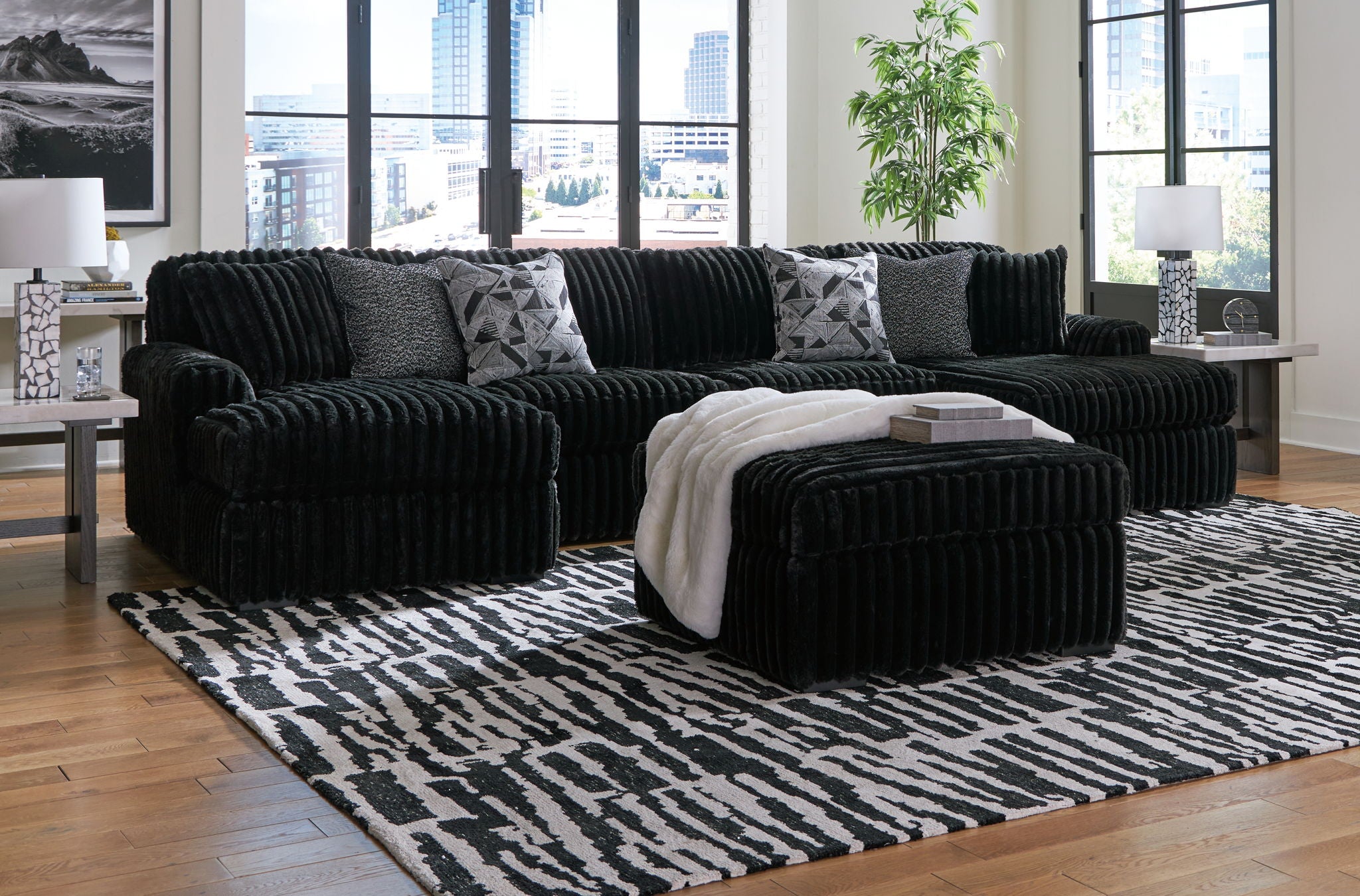 Black sectional sofa set with chaise lounge and coordinating ottoman pieces
