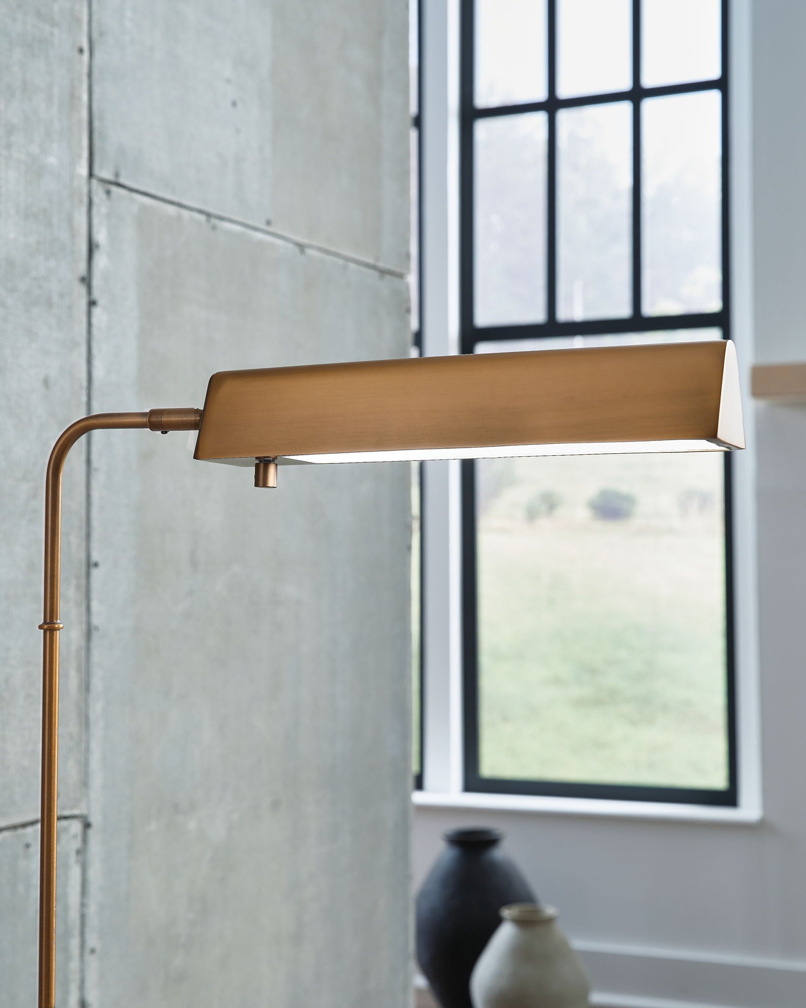Bronze metal floor lamp with rectangular shade, curved arm, and stone base