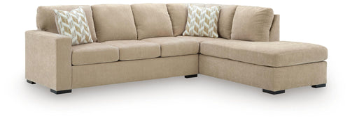 Light brown sectional sofa with corner chaise, seat cushions, and patterned throw pillows