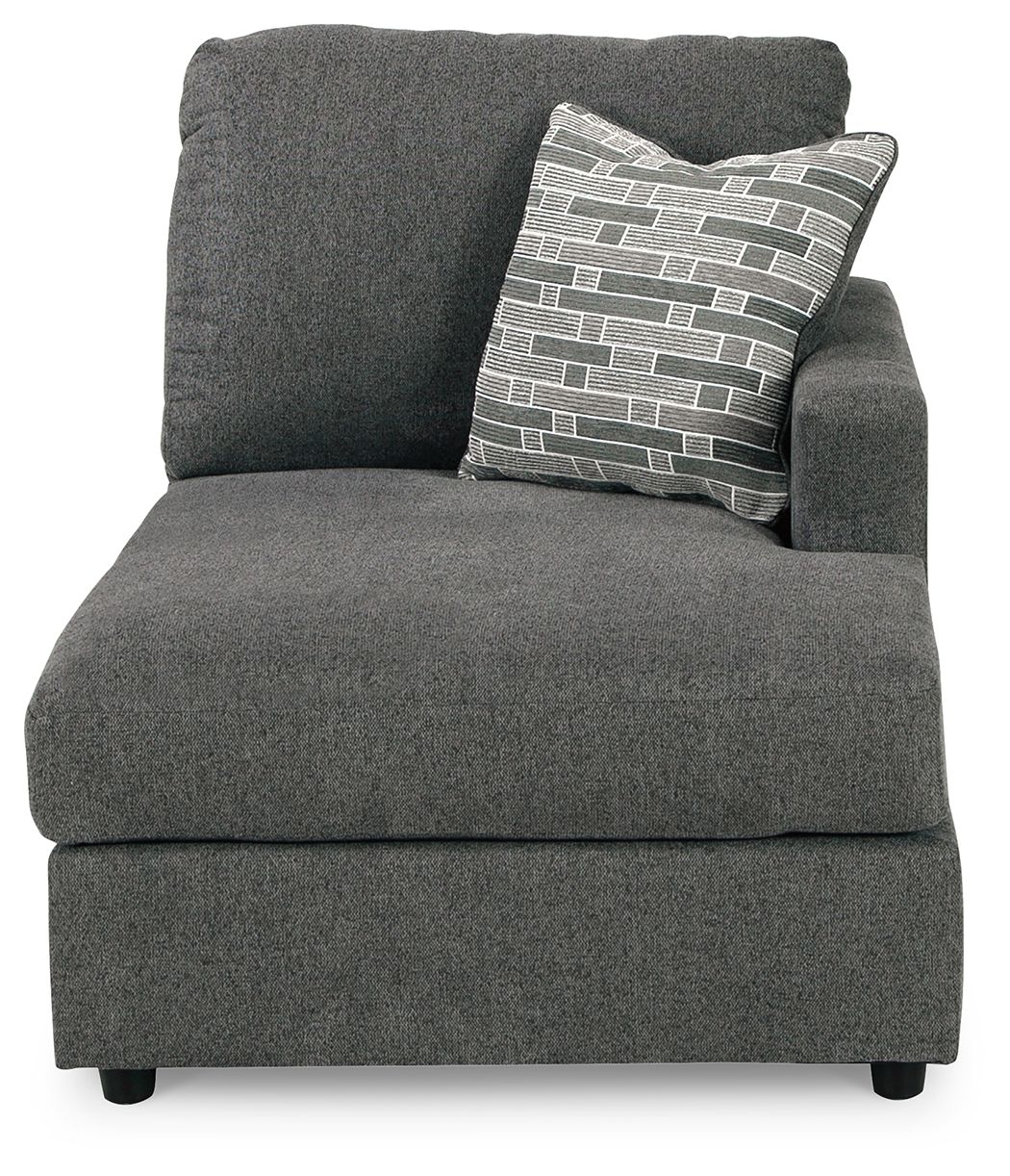 Dark gray corner chaise with tall backrest and patterned throw pillow