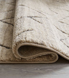 Gray rug edge with short pile and stitched border