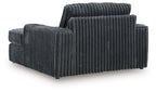 Oversized chaise with ribbed dark gray fabric, broad track arms and raised back cushion.