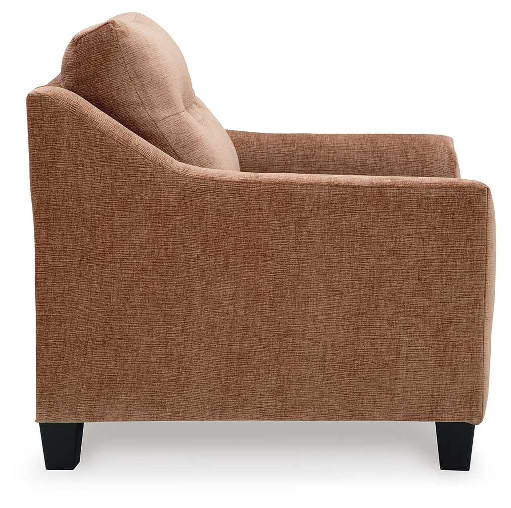 Brown upholstered sofa with chaise end and black feet