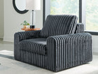 Gunmetal corduroy power gliding chaise with tall backrest and padded armrests.