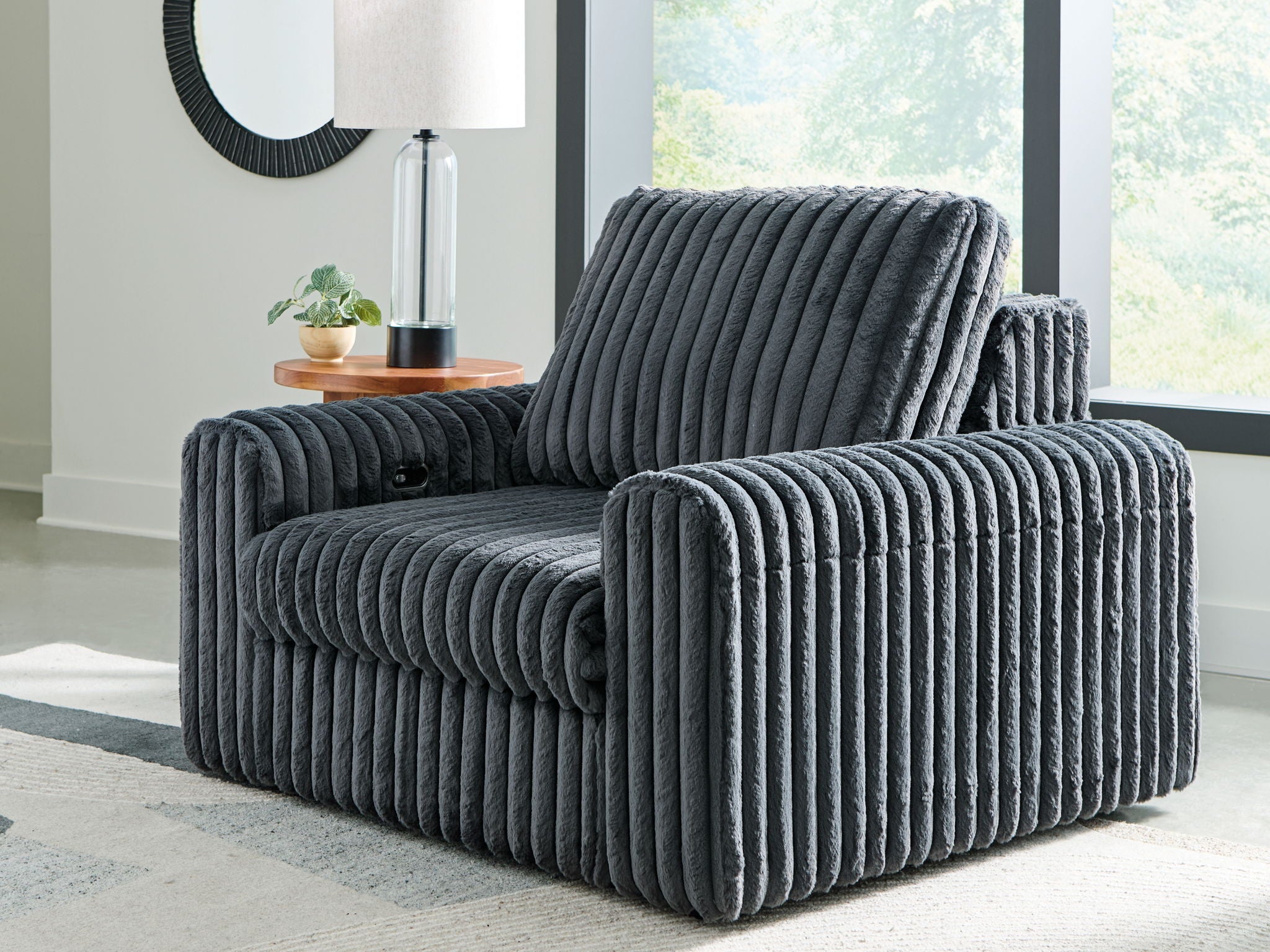 Gunmetal corduroy power gliding chaise with tall backrest and padded armrests.