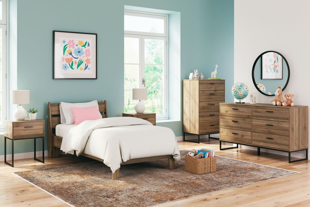 Light brown bed with nightstand and dresser, with round mirror