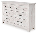 Whitewash six-drawer dresser with black bar pulls and round knob accents