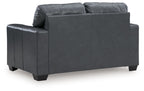Gray loveseat sofa shown from the side with arm pads and dark square feet