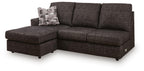 Dark gray fabric sofa chaise with chaise extension, tufted seat, and throw pillow