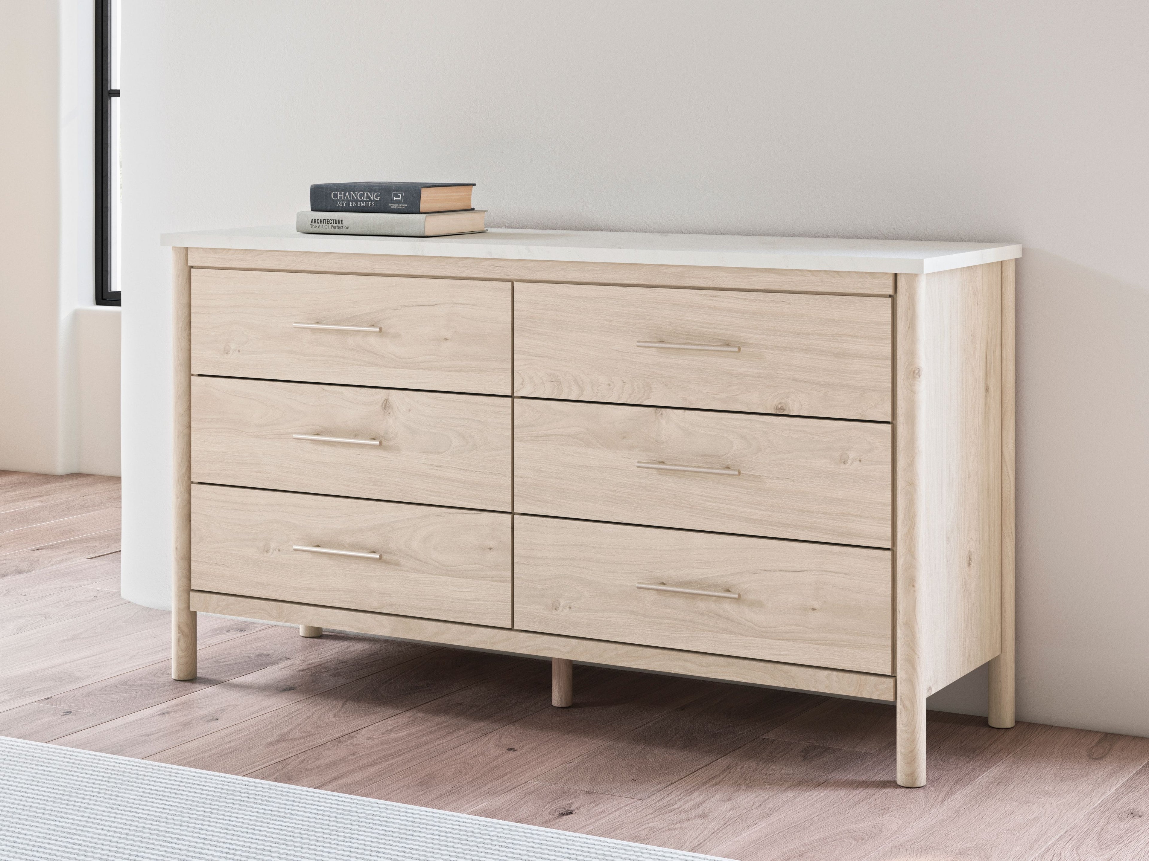 Light wood six-drawer dresser with top drawers visible and bar pulls