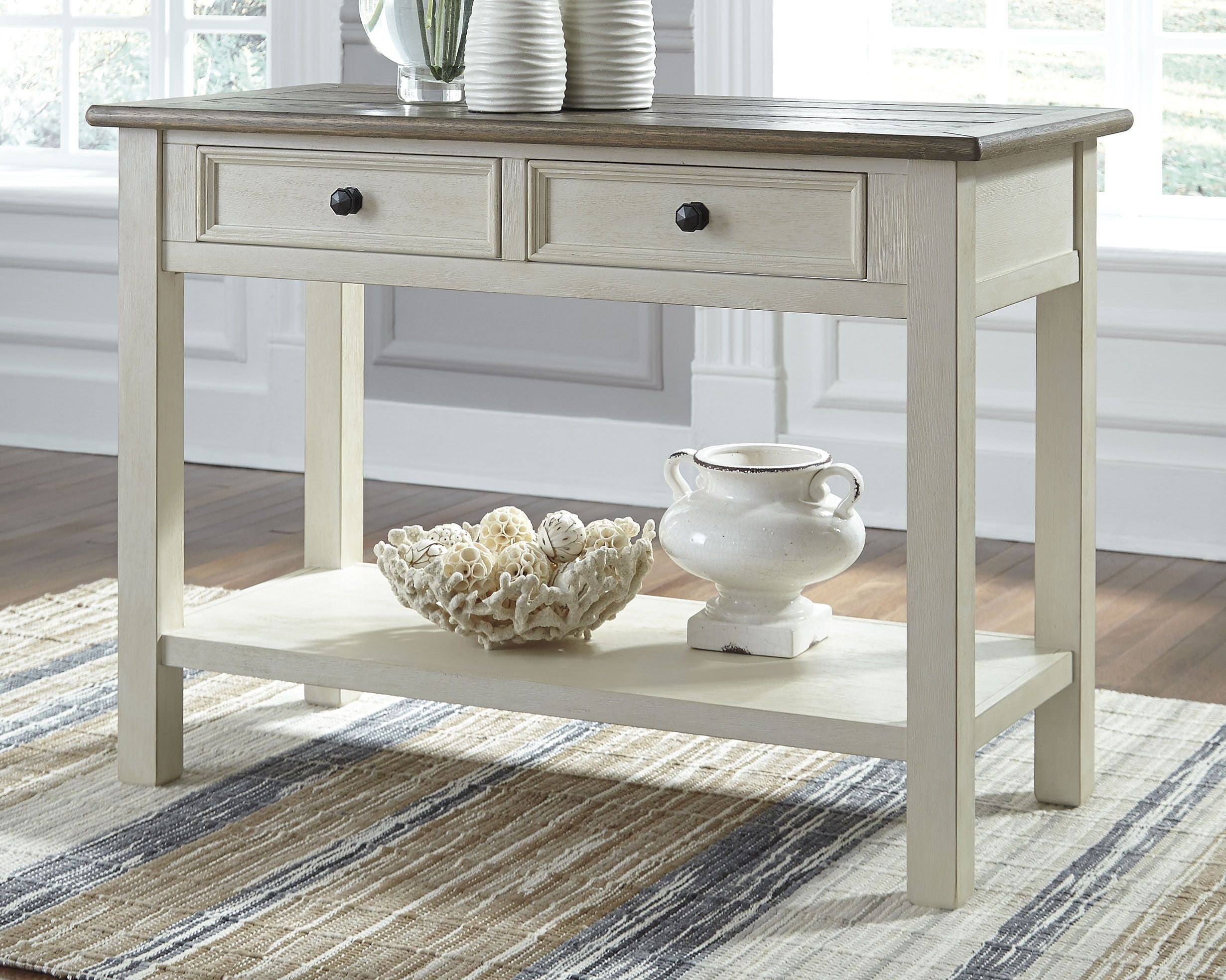 White sofa table with two drawers and dark wood top, lower shelf