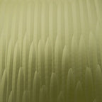 Green glass vase close-up showing vertical ridged texture across the body.
