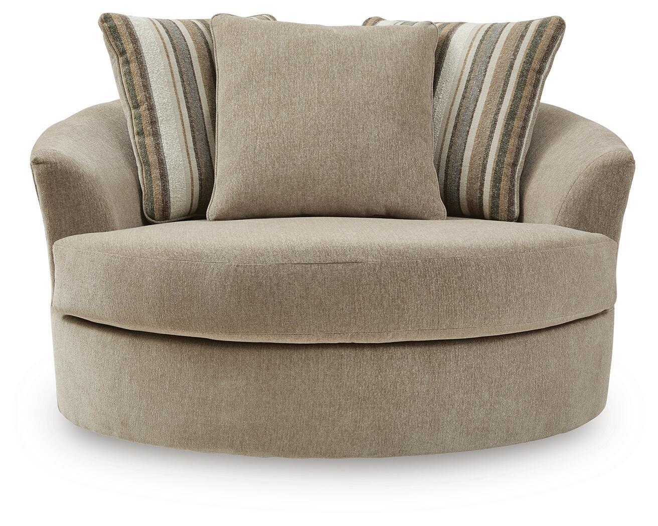 Oversized accent chair with beige upholstery and two striped pillows on the back.