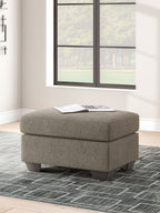 Triston-Peaks upholstered ottoman with textured taupe fabric and dark legs