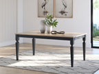 Rectangular dining room table with light wood top and dark legs