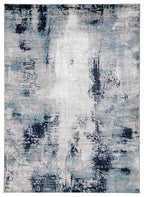 Abstract blue and gray area rug with light center and dark blotches