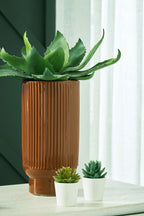 Dark brown cylindrical vase with vertical ridged texture and terracotta base