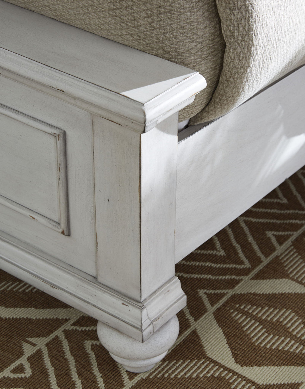 White panel bed corner leg and side panel with inset molding detail.