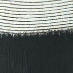 Close-up of black and white ceramic vase rim with horizontal stripe texture