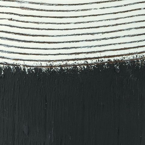 Close-up of black and white ceramic vase rim with horizontal stripe texture