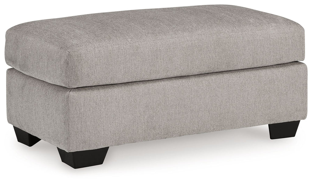 Light gray flannel ottoman with dark legs, padded seat, rounded top