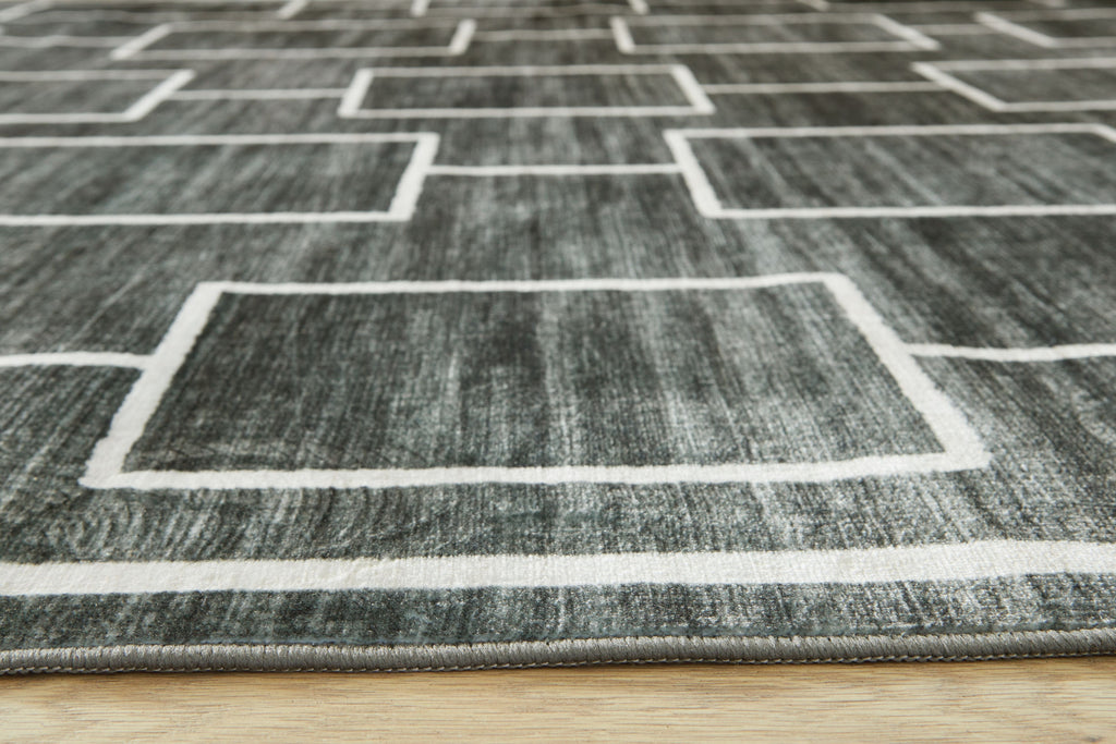 Elderland washable rug close-up of white-lined rectangles on dark gray pile