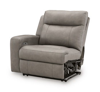Gray upholstered power recliner with footrest; power base mechanism visible.