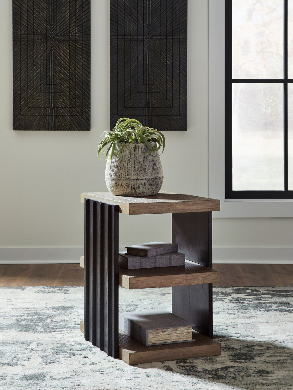 Rectangular end table with black side slats and light brown top and three-tier shelves