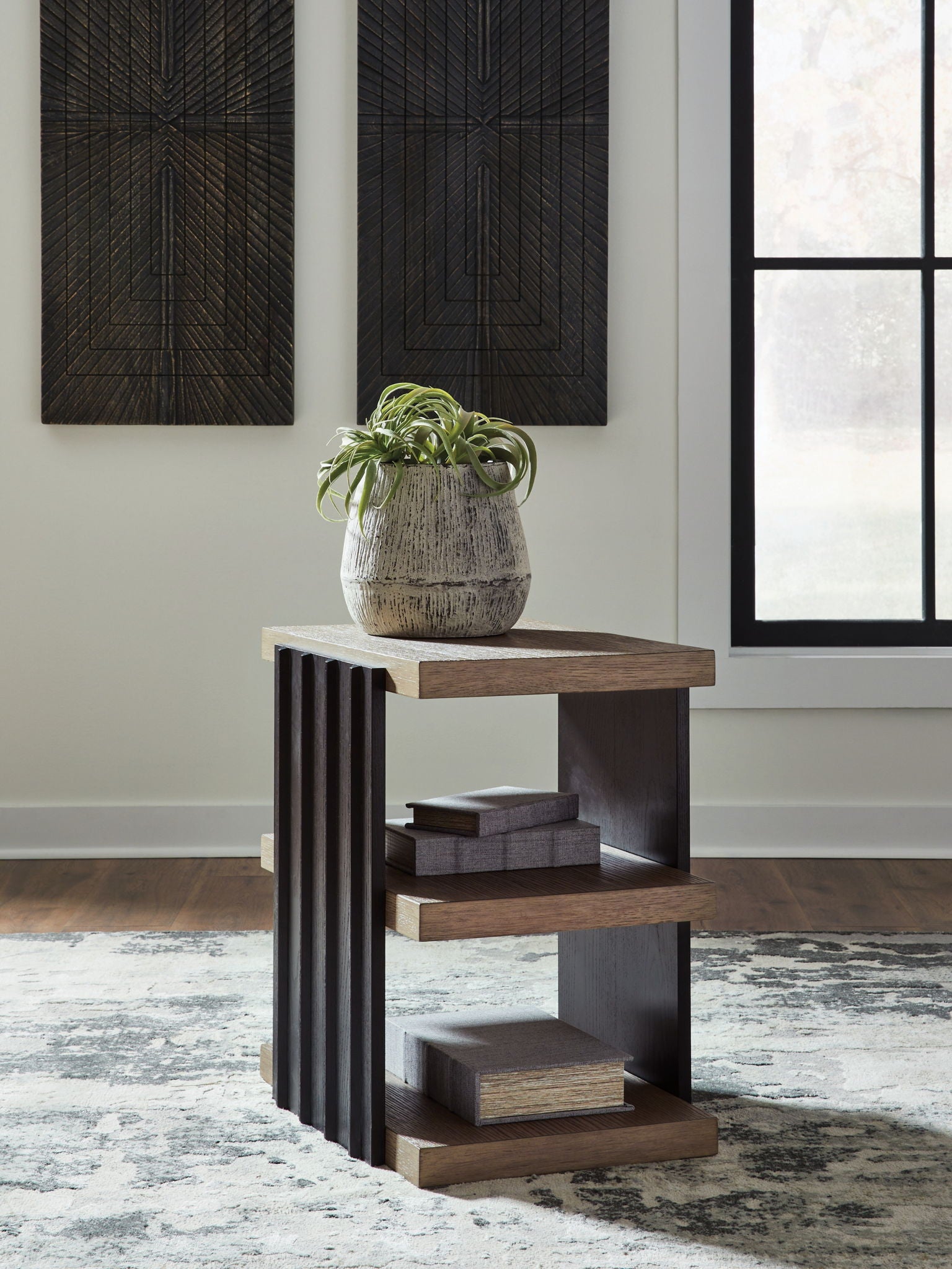 Rectangular end table with black side slats and light brown top and three-tier shelves