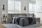 Gray sectional sleeper sofa with pull-out mattress and tufted back cushions
