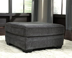 Slate gray upholstered accent ottoman with rounded top and square black legs