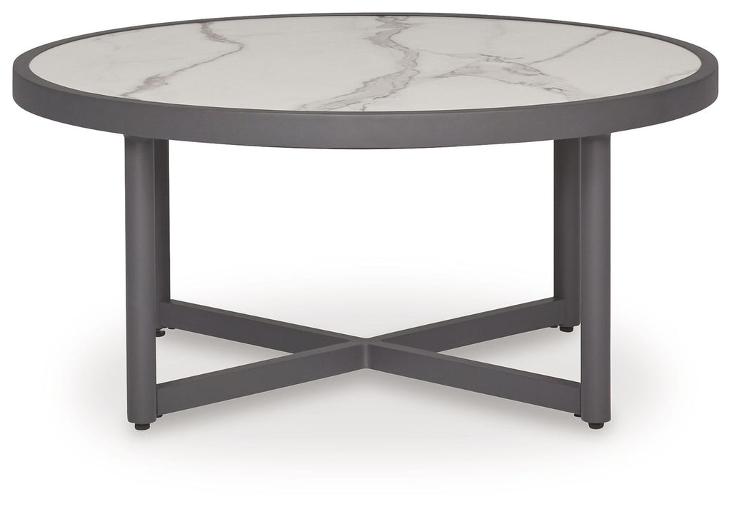 Gray round table with white marble-look top and crossed base support
